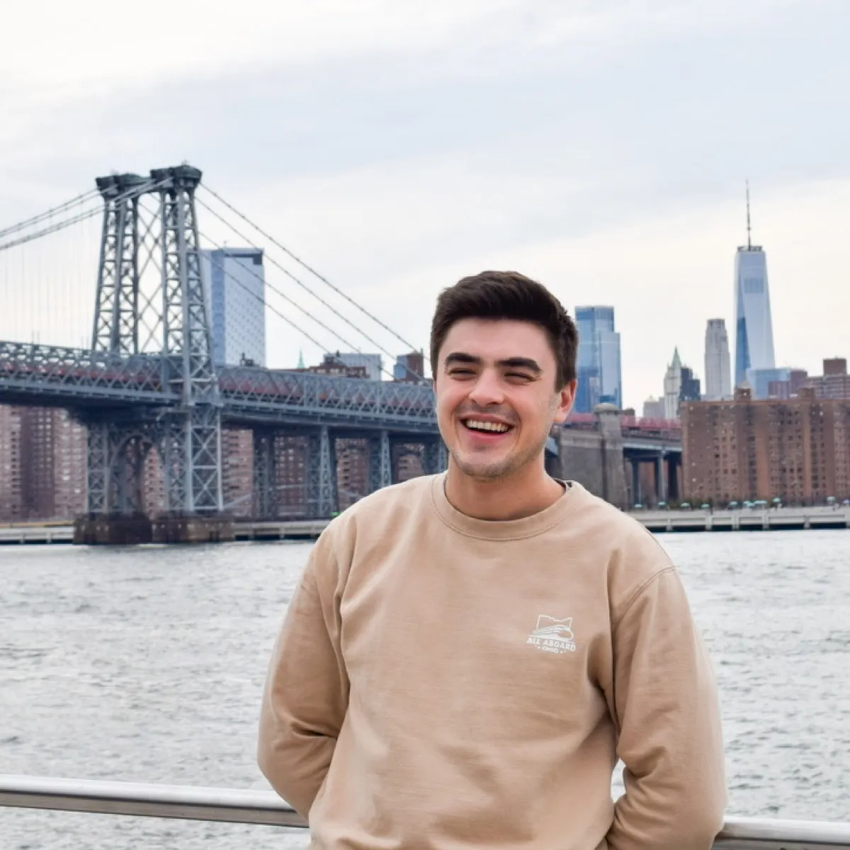 Mitch Radakovich in front of the Williamsburg Bridge and Manhattan skyline